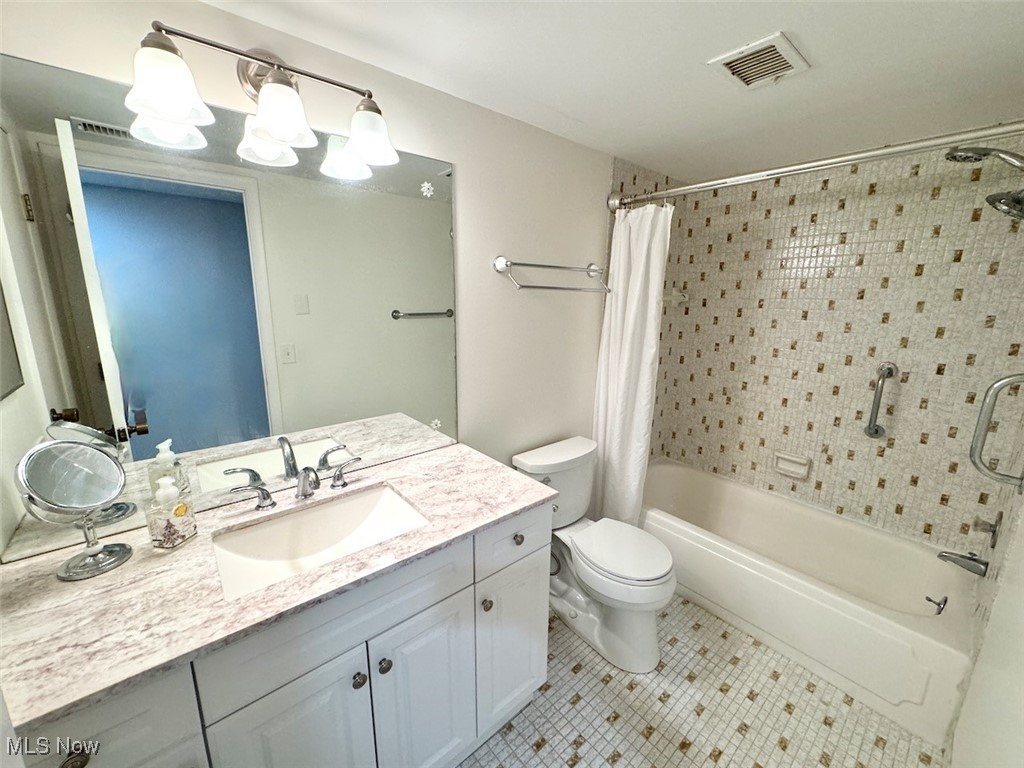 3701 Mayfield Road, Unit 207 Cleveland, OH 44121 - Photo 21 of 30 Full bathroom featuring tile patterned flooring, vanity, toilet, and shower / tub combo with curtain