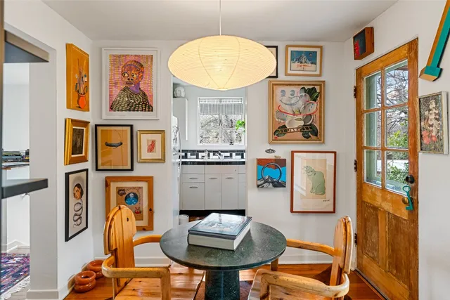 a view of a workspace with furniture and a window