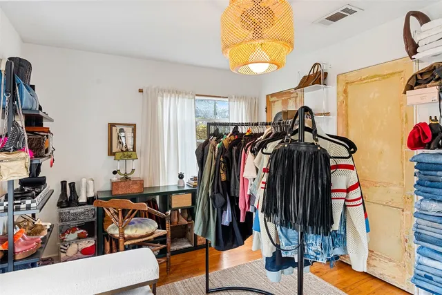 a view of walk in closet with clothes and shoes
