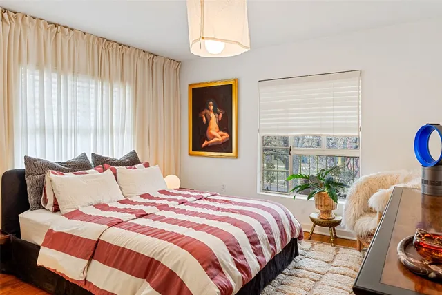 a bedroom with bed and a window