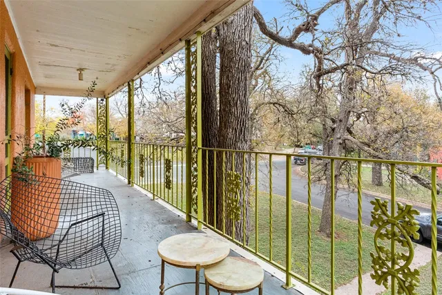 a view of balcony with wooden floor and outdoor seating