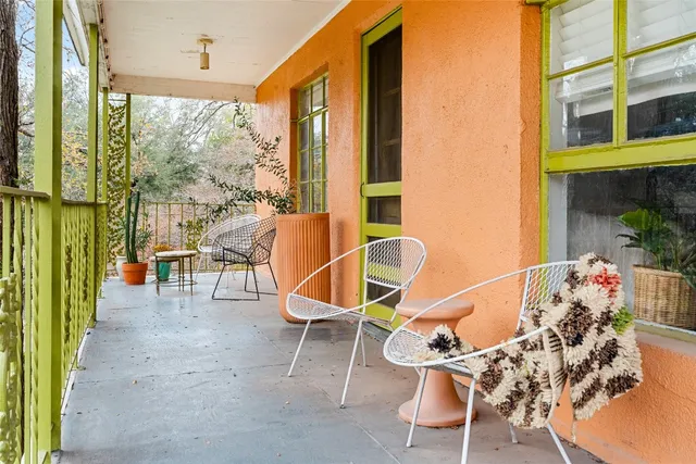 a dining room with furniture water view and a floor to ceiling window