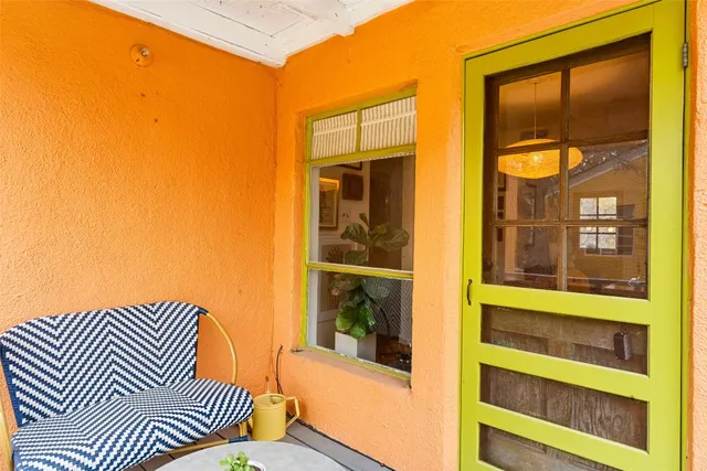 a view of a balcony with a door and a window