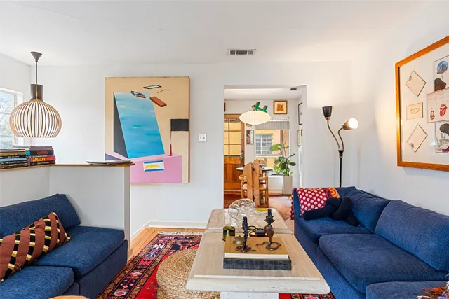 a living room with furniture and a lamp