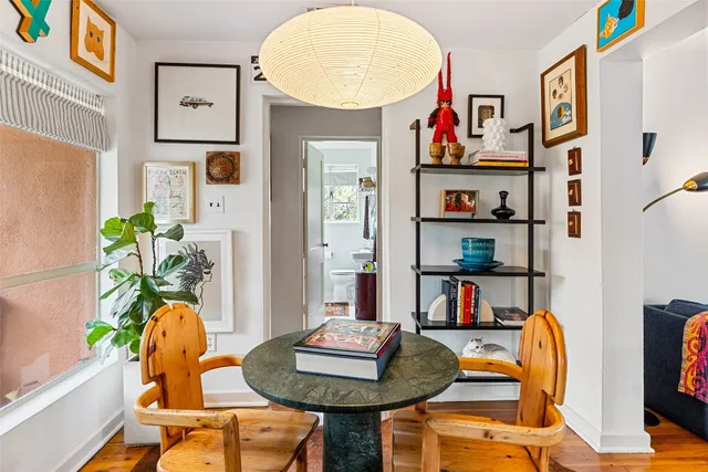 a living room with furniture and a book shelf