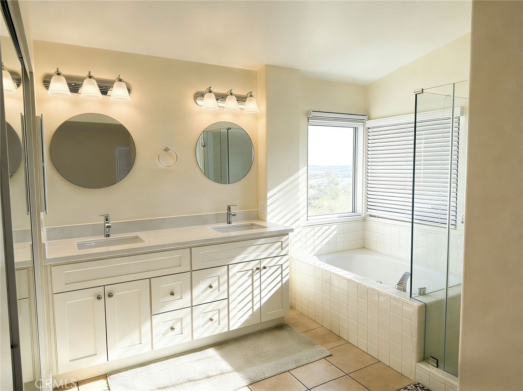 2115 Sun Ridge Drive Chino Hills, CA 91709 - Photo 4 of 9 a bathroom with a granite countertop sink and a mirror