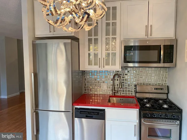 a kitchen with stainless steel appliances a stove and a refrigerator