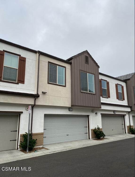 105 Red Brick Drive, Unit 3 Simi Valley, CA 93065 - Photo 2 of 14 a front view of a house with garage