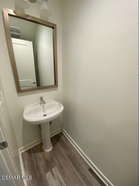 105 Red Brick Drive, Unit 3 Simi Valley, CA 93065 - Photo 10 of 14 a bathroom with a sink a toilet and mirror