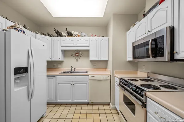 a kitchen with stainless steel appliances a stove a sink and a refrigerator