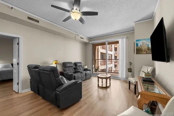 a living room with furniture flat screen tv and a large window