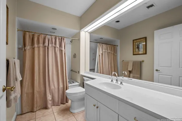 a bedroom with a bed and flat screen tv