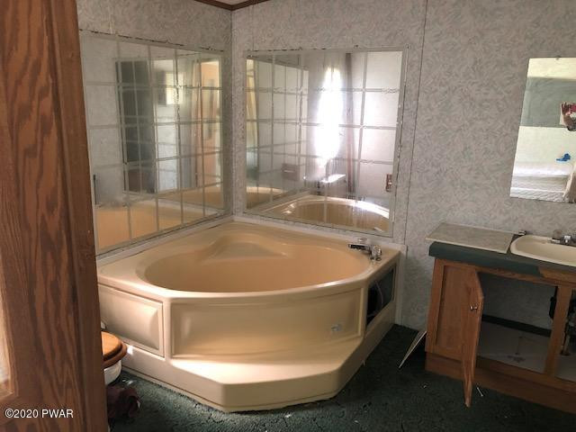 213 Slish Road Honesdale, PA 18431 - Photo 9 of 13 a white bath tub sitting in a bathroom