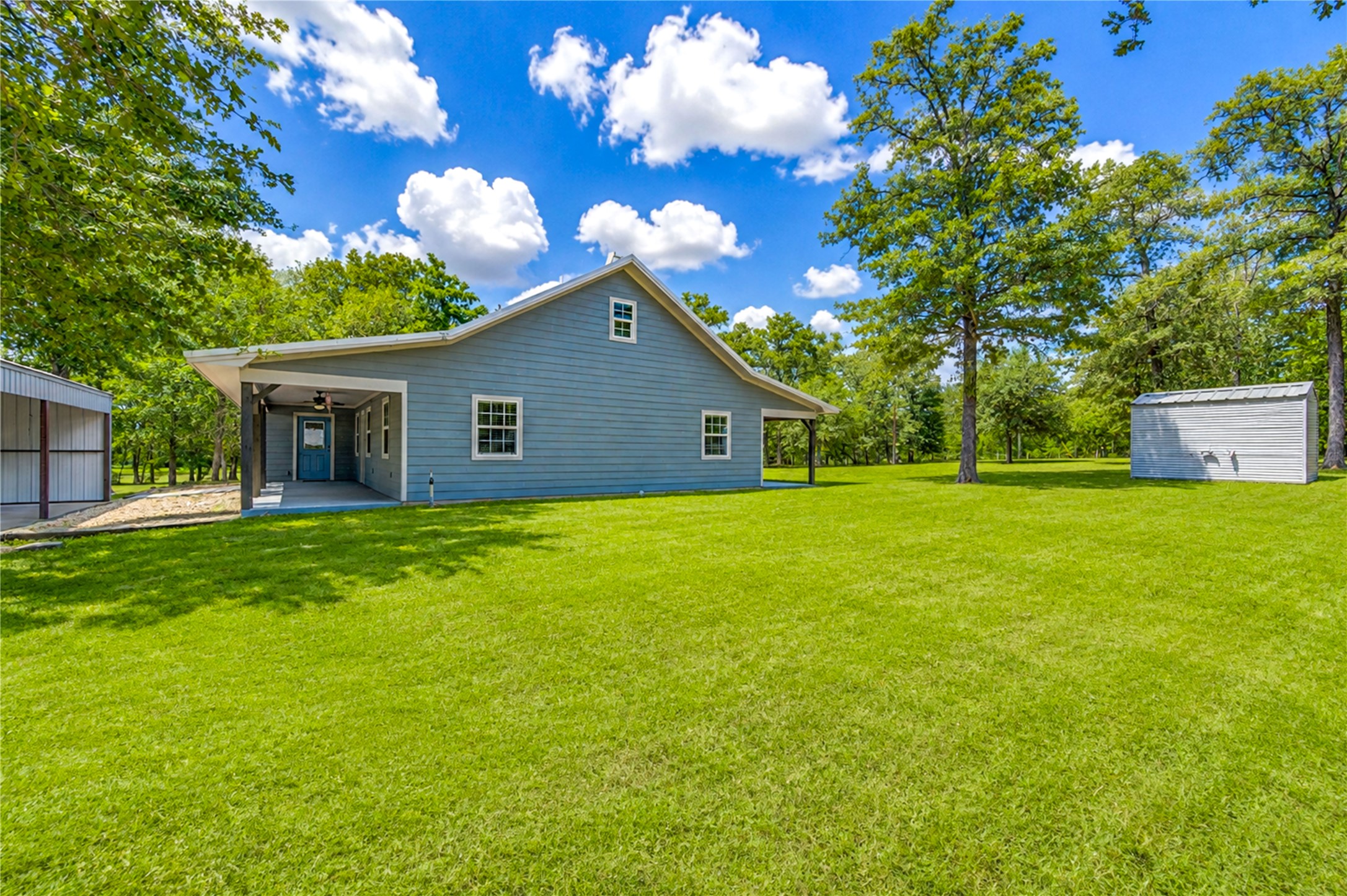8805 Sun Oil Road Brenham, TX 77833 - Photo 8 of 50 Charming home with a spacious lawn, mature trees, and a covered porch perfect for relaxing outdoors.
