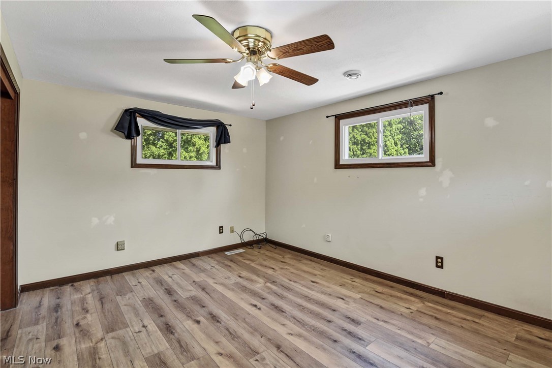 301 Crosse Road Amherst, OH 44001 - Photo 35 of 49 Spacious room featuring wood-finish flooring, light-toned walls, and a ceiling fan with integrated lighting