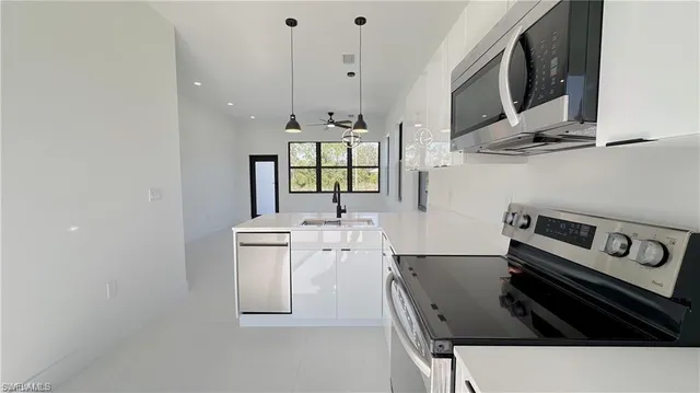 a kitchen with stainless steel appliances a stove and a refrigerator