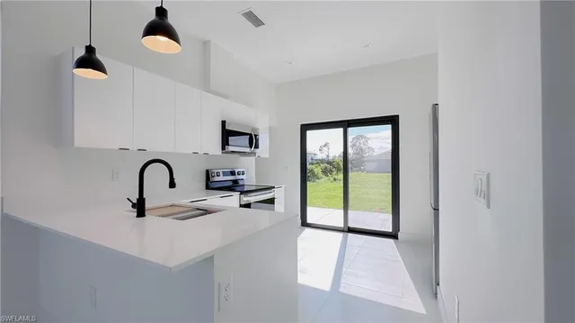 a view of a kitchen with a sink and a window