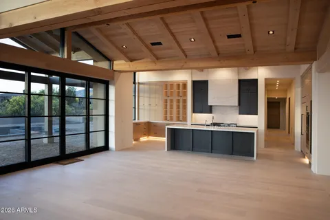 a large room with a large window and furniture
