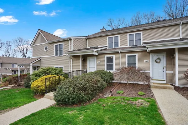 a front view of house with yard and green space