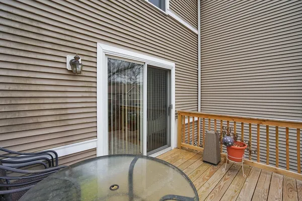 a view of a chair and table in front of a house