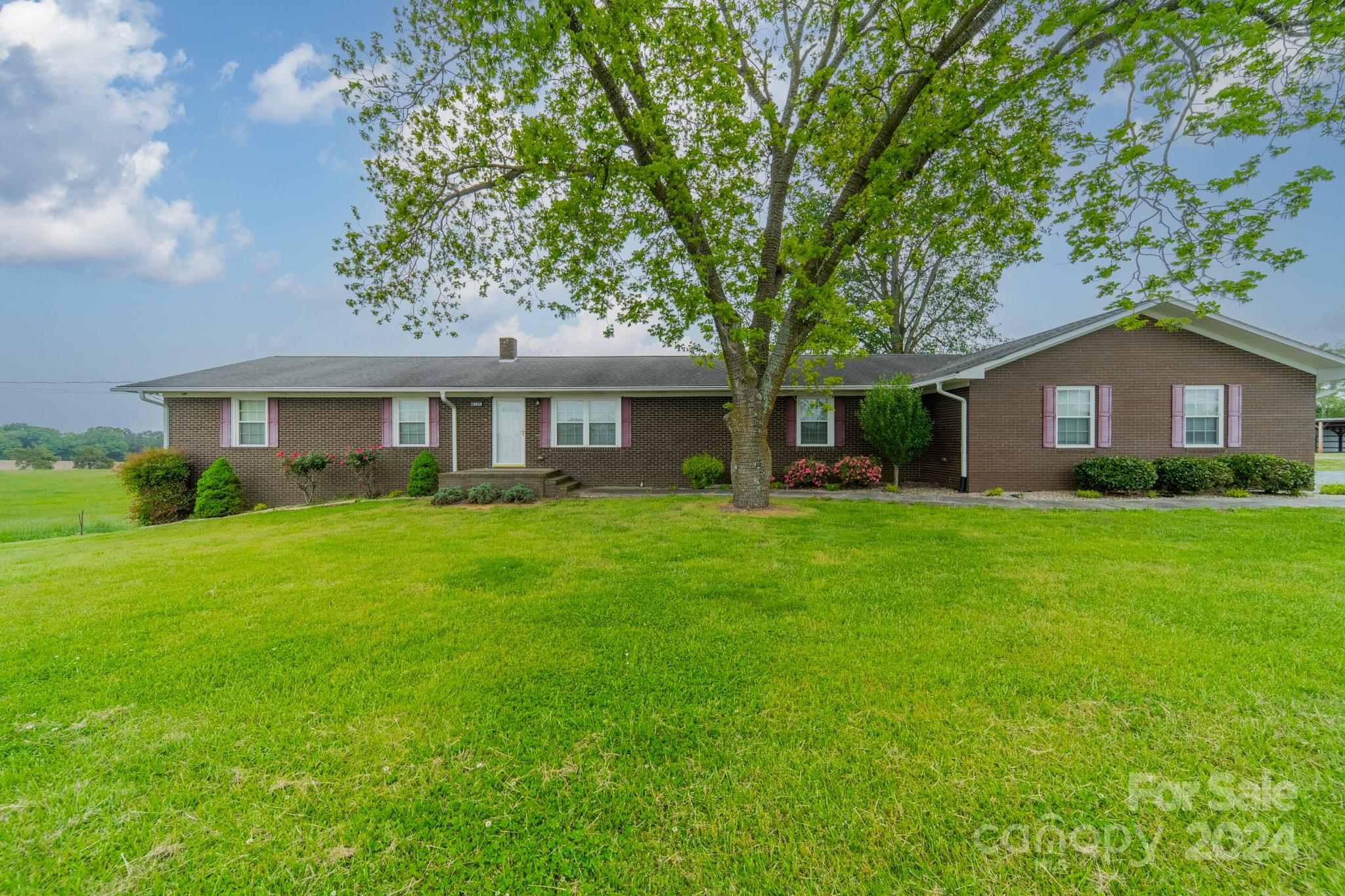 24686 Barbees Grove Road Oakboro, NC 28129 - Photo 1 of 35 a front view of house with yard and green space