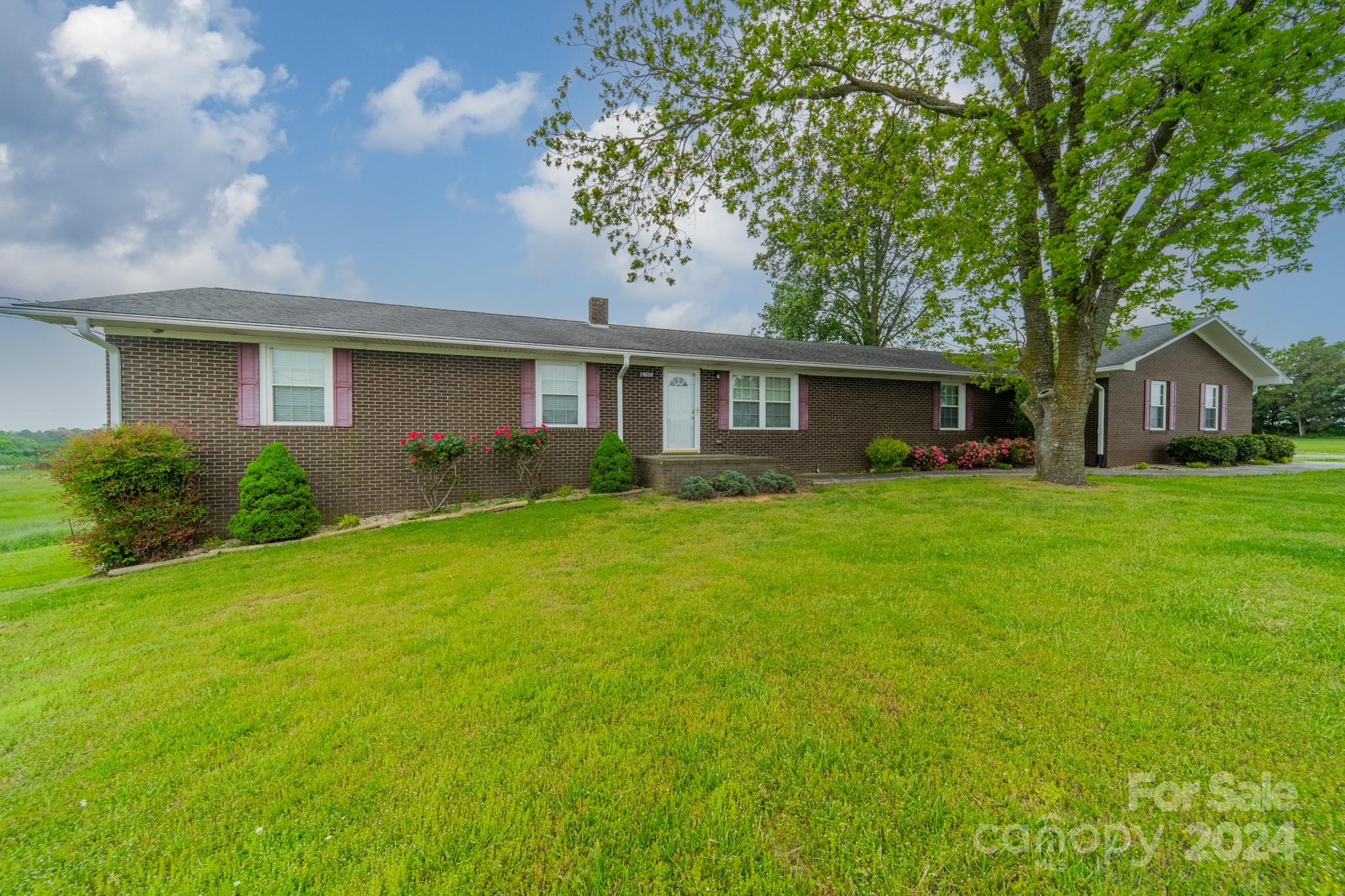 24686 Barbees Grove Road Oakboro, NC 28129 - Photo 2 of 35 a front view of house with yard and green space