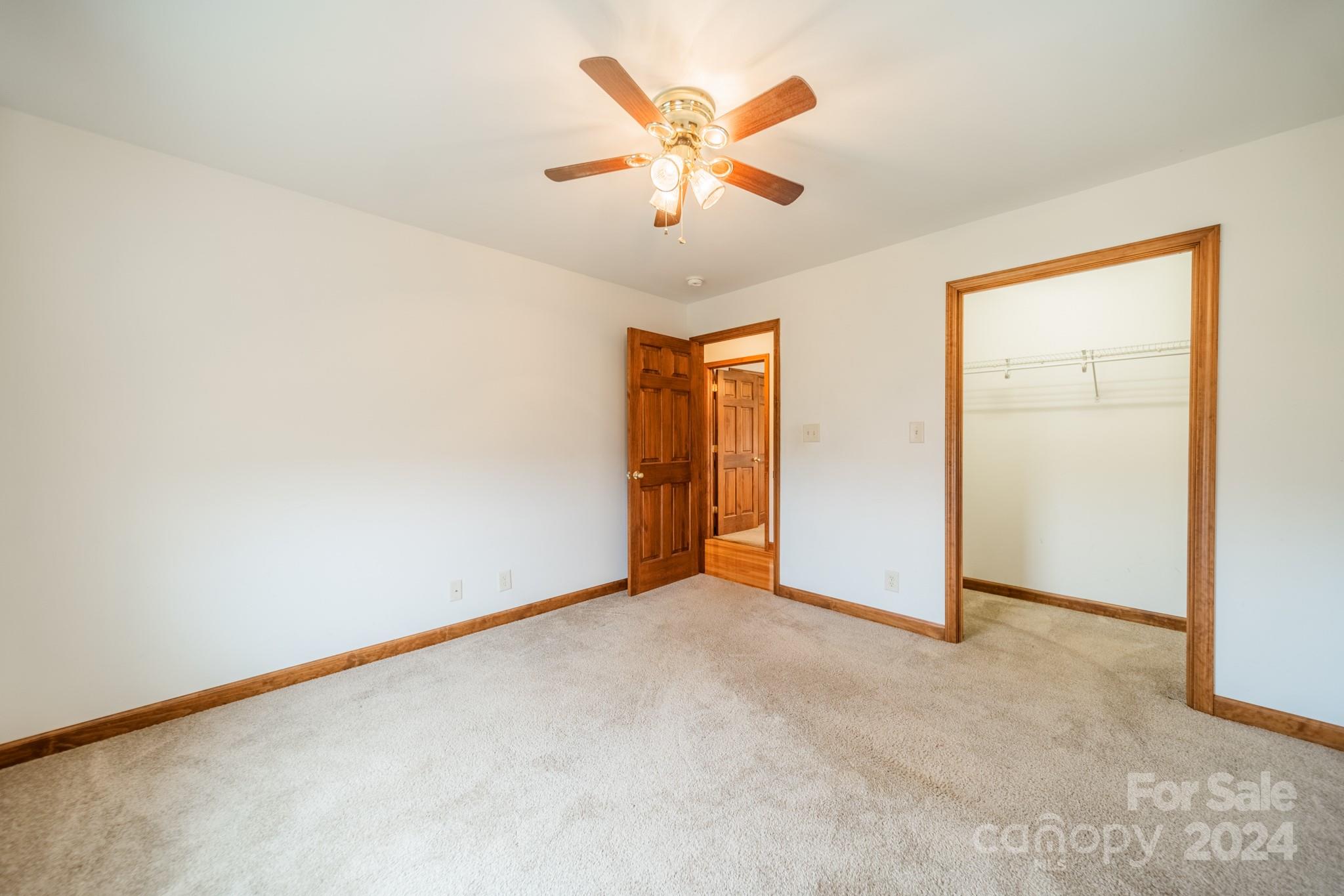 24686 Barbees Grove Road Oakboro, NC 28129 - Photo 23 of 35 an empty room with closet and fan