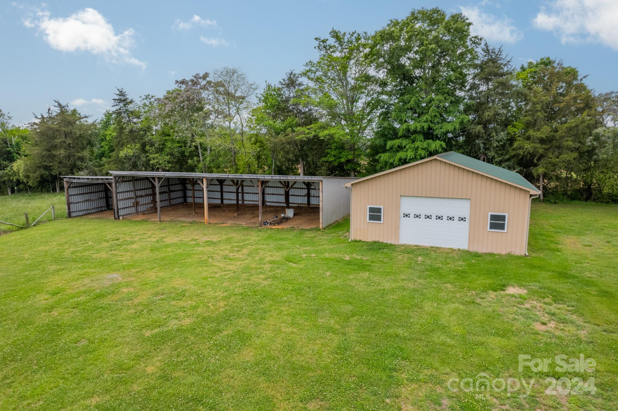 24686 Barbees Grove Road Oakboro, NC 28129 - Photo 25 of 35 a view of a house with a backyard and a garden