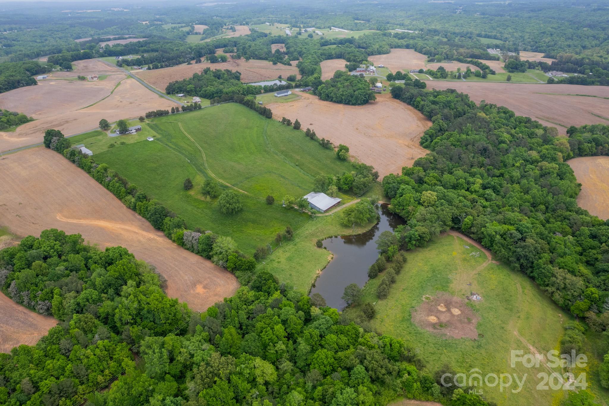 24686 Barbees Grove Road Oakboro, NC 28129 - Photo 28 of 35 an aerial view of lake residential houses with outdoor space and trees
