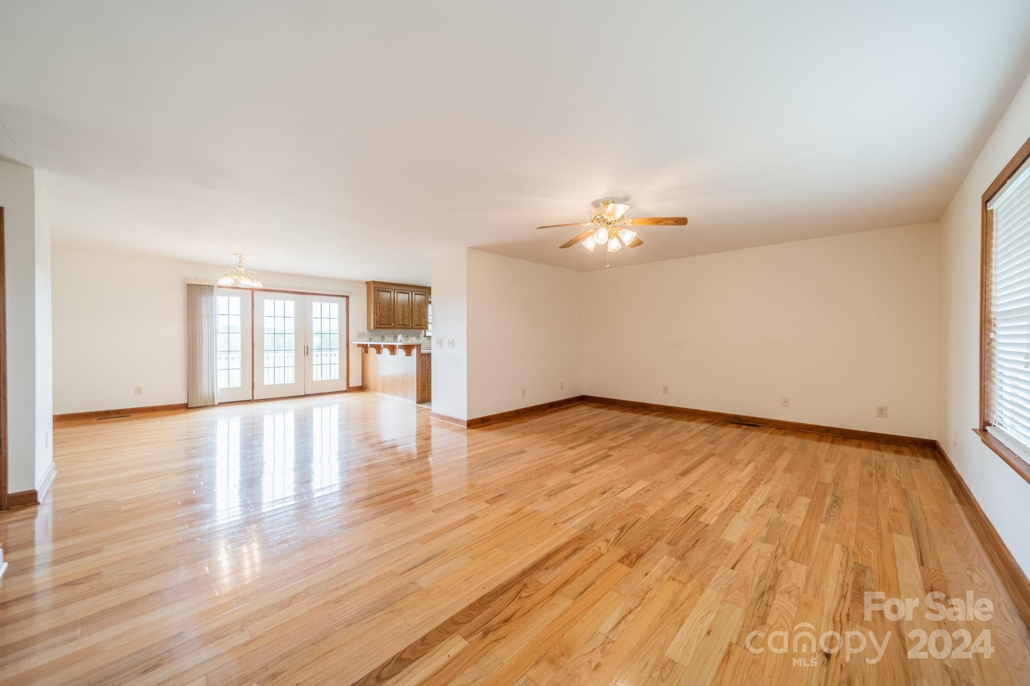 24686 Barbees Grove Road Oakboro, NC 28129 - Photo 8 of 35 a view of an empty room with wooden floor and a window
