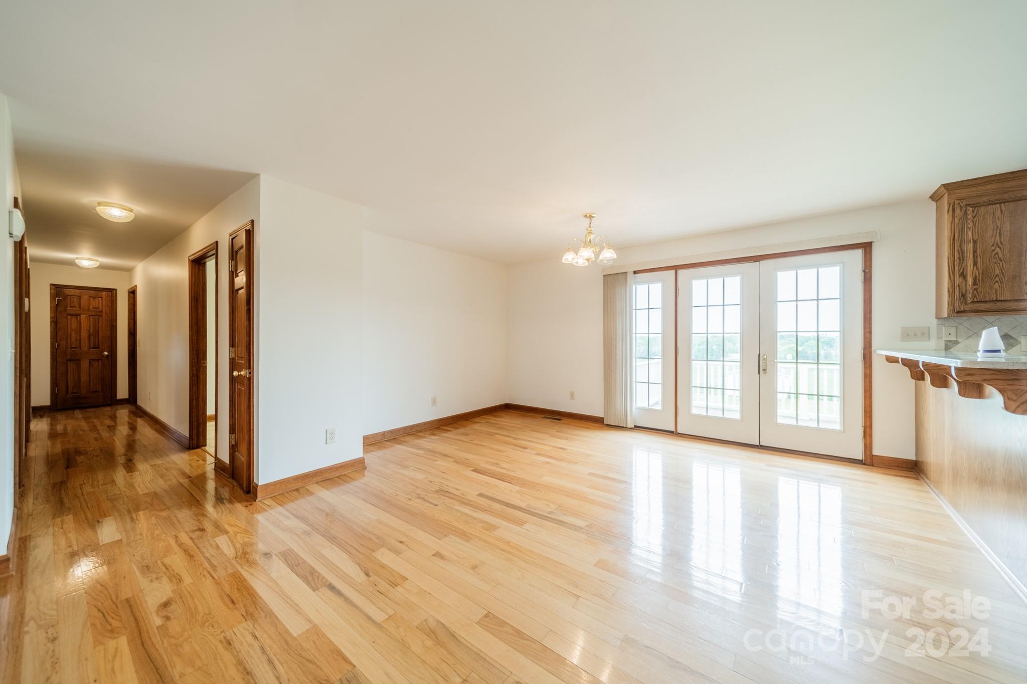 24686 Barbees Grove Road Oakboro, NC 28129 - Photo 10 of 35 a view of an empty room with wooden floor and a window