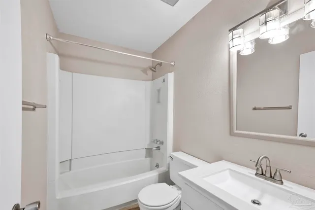 a view of a house with a yard and pathway