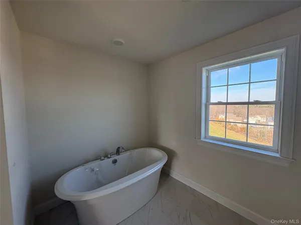a white bath tub sitting in a bathroom