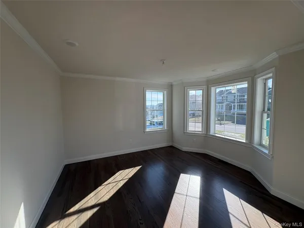 a view of room with window and wooden floor