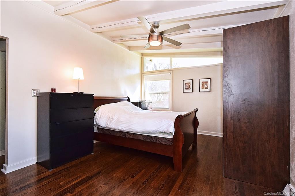 3111 Spring Valley Road Charlotte, NC 28210 - Photo 12 of 24 a bed sitting in a bedroom next to a window