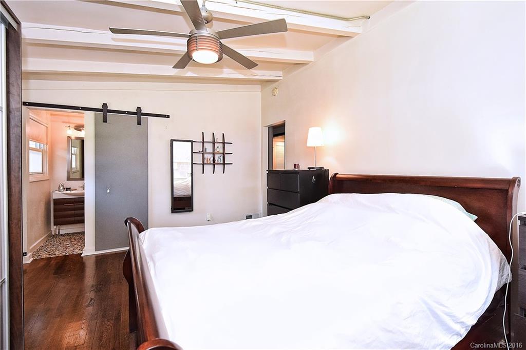 3111 Spring Valley Road Charlotte, NC 28210 - Photo 13 of 24 a bedroom with a bed and a chandelier