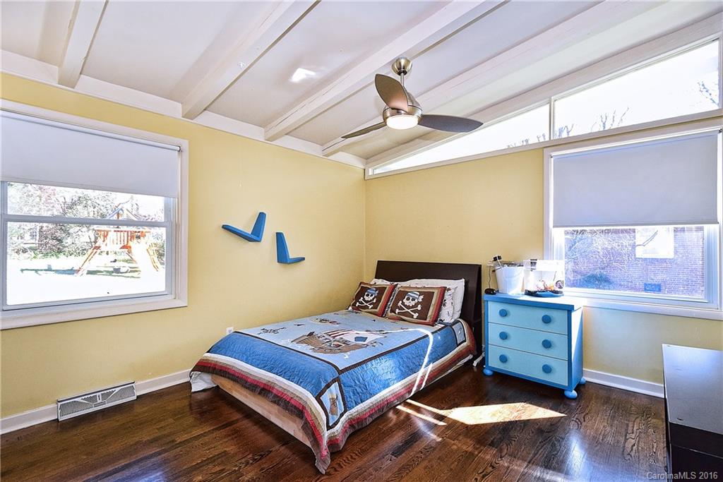 3111 Spring Valley Road Charlotte, NC 28210 - Photo 15 of 24 a bedroom with a bed and wooden floor