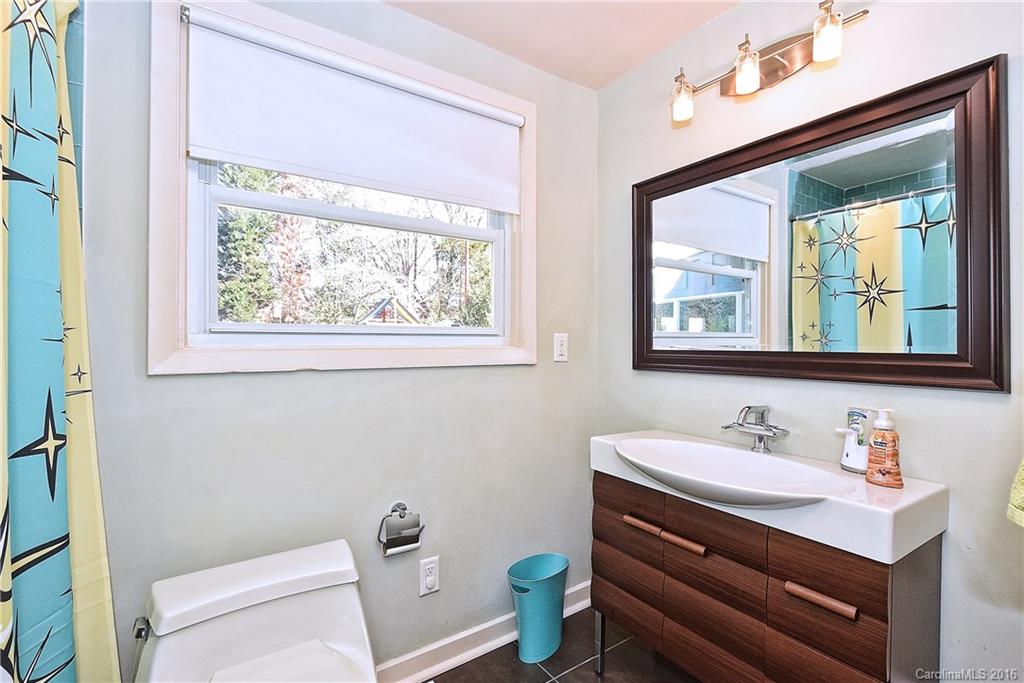 3111 Spring Valley Road Charlotte, NC 28210 - Photo 17 of 24 a bathroom with a sink mirror vanity and a toilet