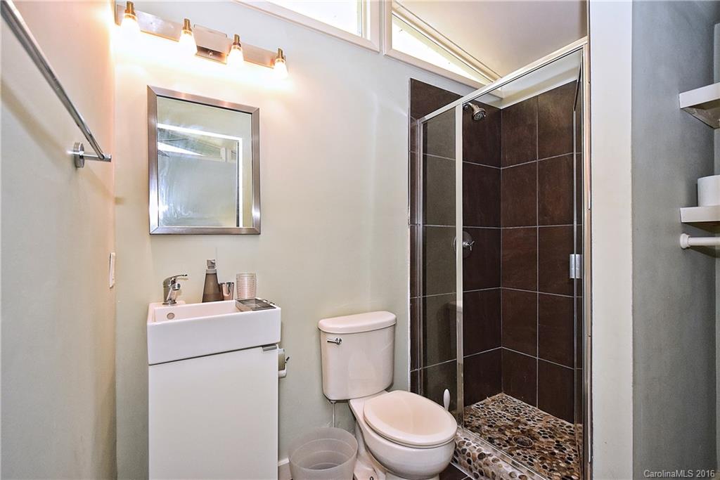 3111 Spring Valley Road Charlotte, NC 28210 - Photo 23 of 24 a bathroom with a toilet a sink and shower