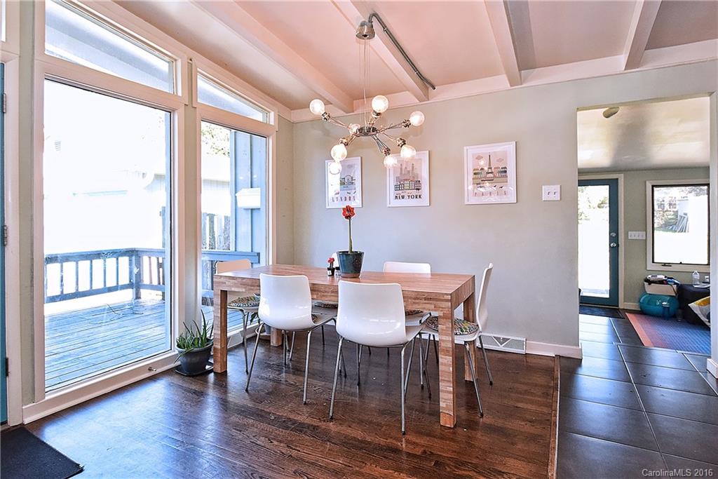 3111 Spring Valley Road Charlotte, NC 28210 - Photo 6 of 24 a view of a dining room with furniture a chandelier and wooden floor