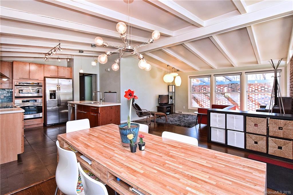 3111 Spring Valley Road Charlotte, NC 28210 - Photo 7 of 24 a view of a dining room with furniture a chandelier and wooden floor