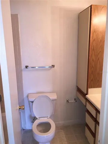 a white toilet sitting next to a shower curtain