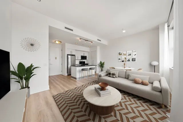 a living room with furniture potted plant and a table
