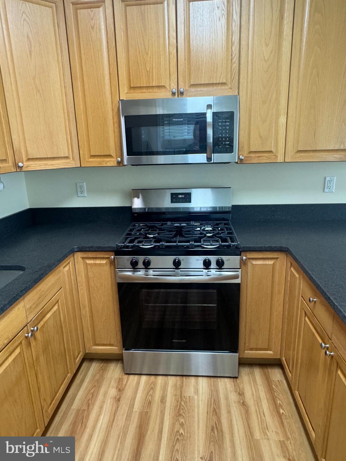 113 Kyle Way Ewing, NJ 08628 - Photo 22 of 25 a kitchen with stainless steel appliances a stove a microwave and cabinets