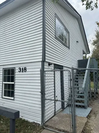 a view of a house with iron stairs