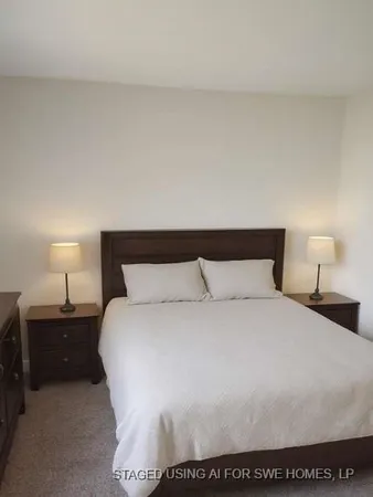 a large bed sitting in a bedroom and lamp