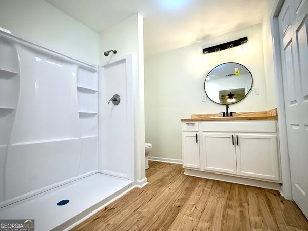 a bathroom with a mirror and a shower