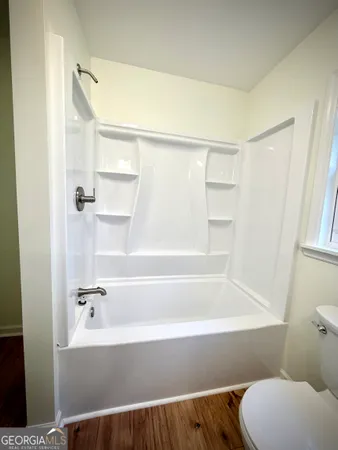 a bathroom with a bathtub and a toilet