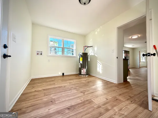 a view of empty room with wooden floor