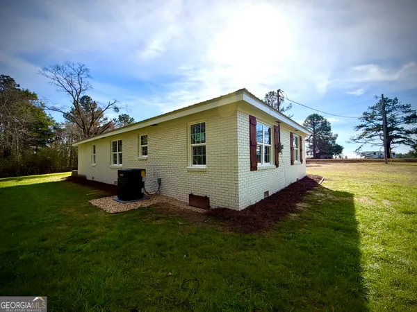 a front view of house with yard and seating area